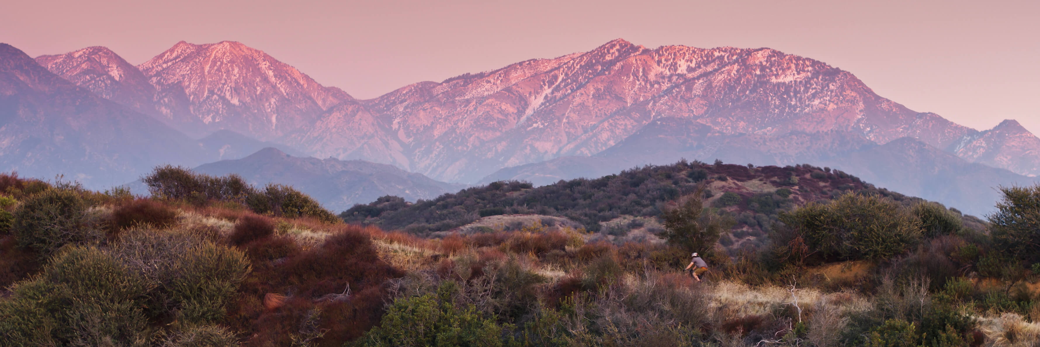 Drone shot of a lone male cyclist on a dirt trail off of Glendora Mountain Road in the San Gabriel Mountains of Southern California.